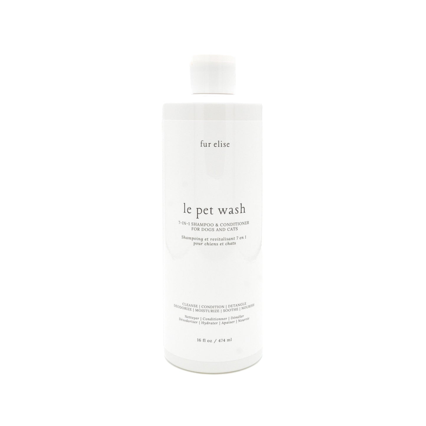 Le Pet Wash bottle beside a folded oat-toned towel and a freshly bathed dog in soft light